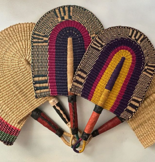 Woven fans with colorful patterns on a light background